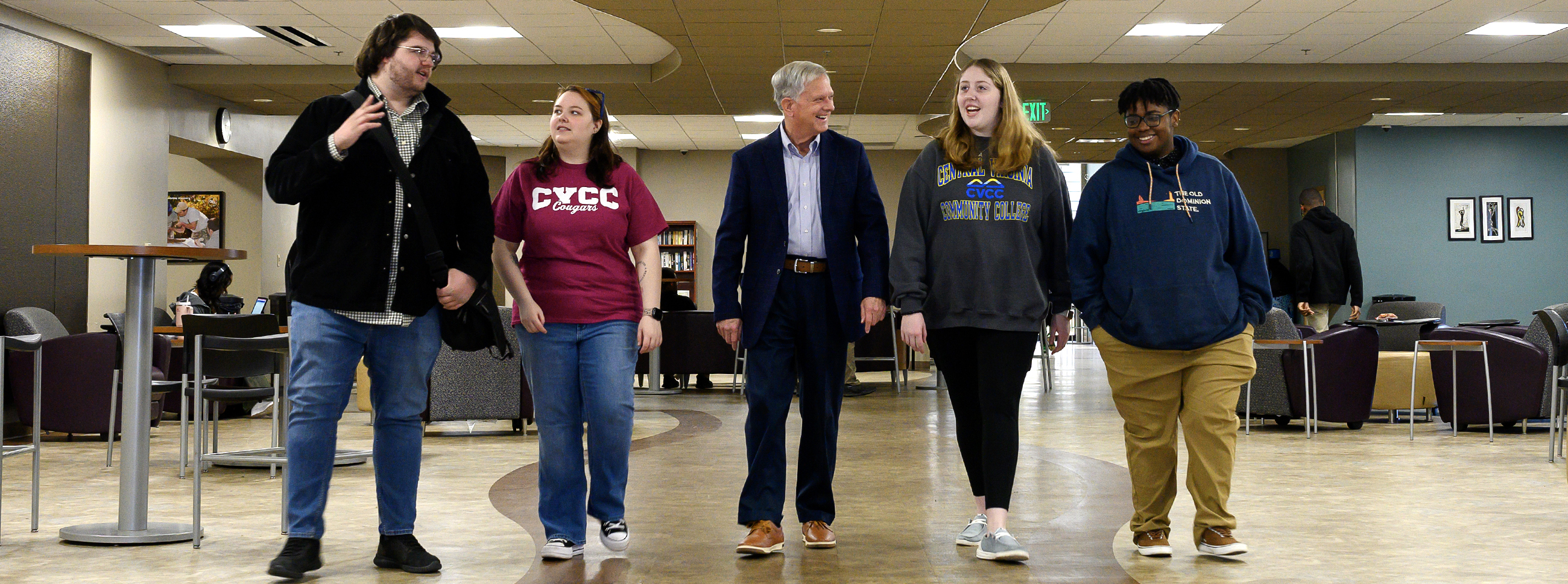 Dr. John Capps walking with four students