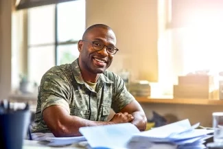 Male Veteran at desk smiling