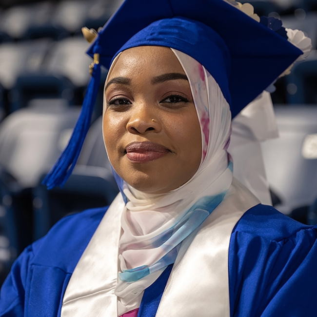 proud female graduate smiling at camera